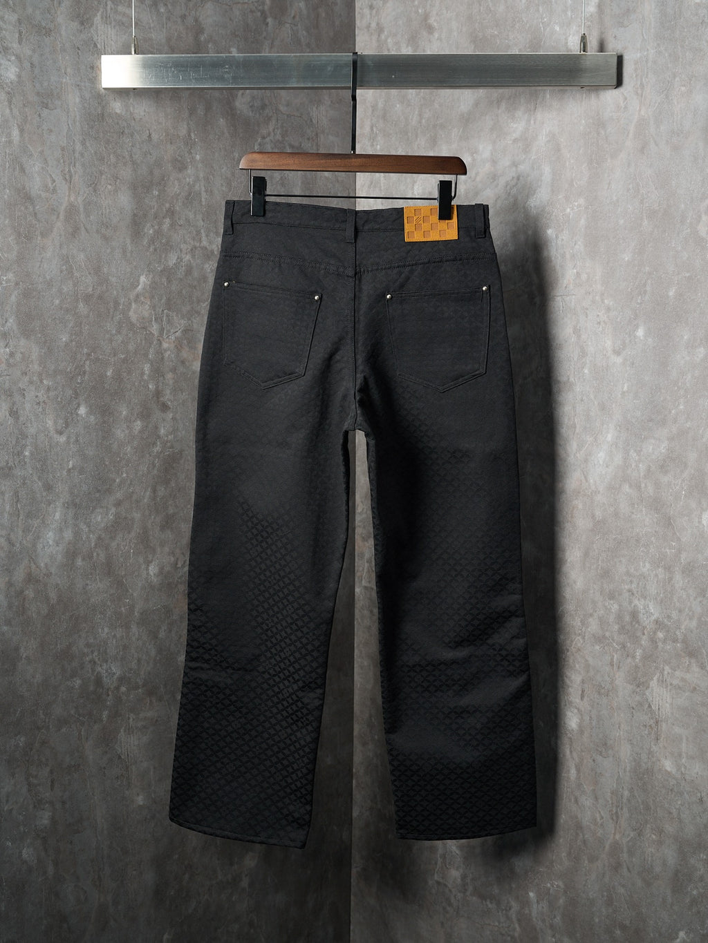 Louis Vuitton pants, dark black, front view with two pockets and button closure at waist