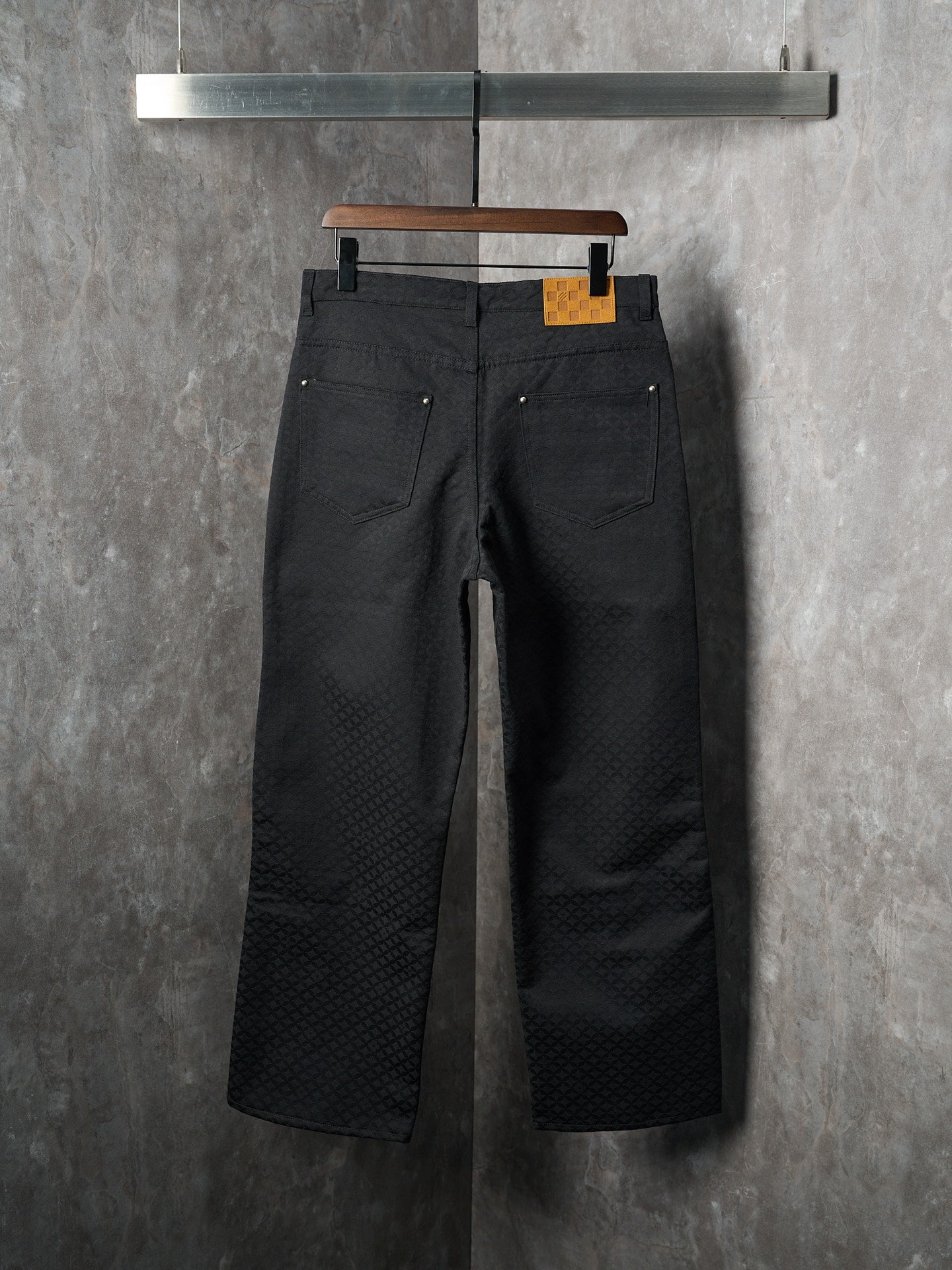 Louis Vuitton pants, dark black, front view with two pockets and button closure at waist