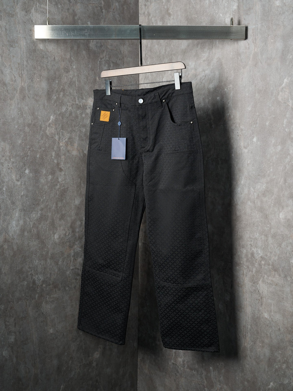 Louis Vuitton pants, dark black, angled view showing belt loops and wide leg silhouette