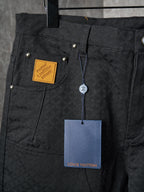 Louis Vuitton pants close-up of front pockets with gold hardware and hanging price tag