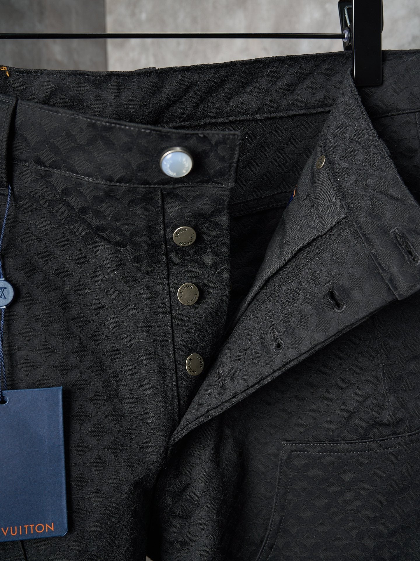 Louis Vuitton pants close-up of waist with snap button placket and inner pocket lining