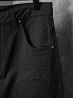 Louis Vuitton pants close-up of front with curved pocket opening and gold button detail