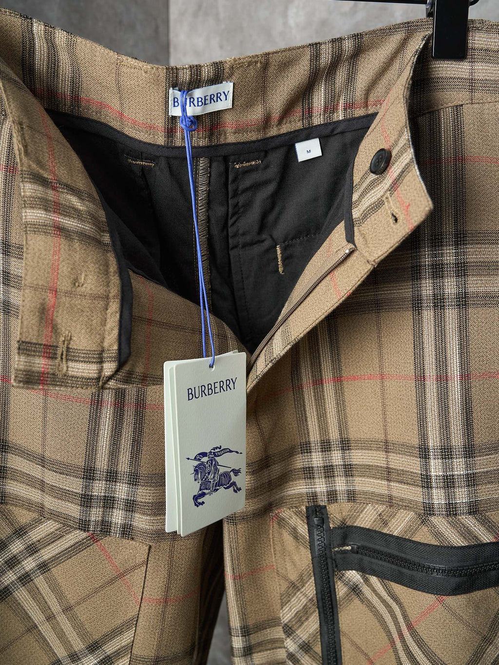 Burberry plaid pants waistband close-up with black lining and button