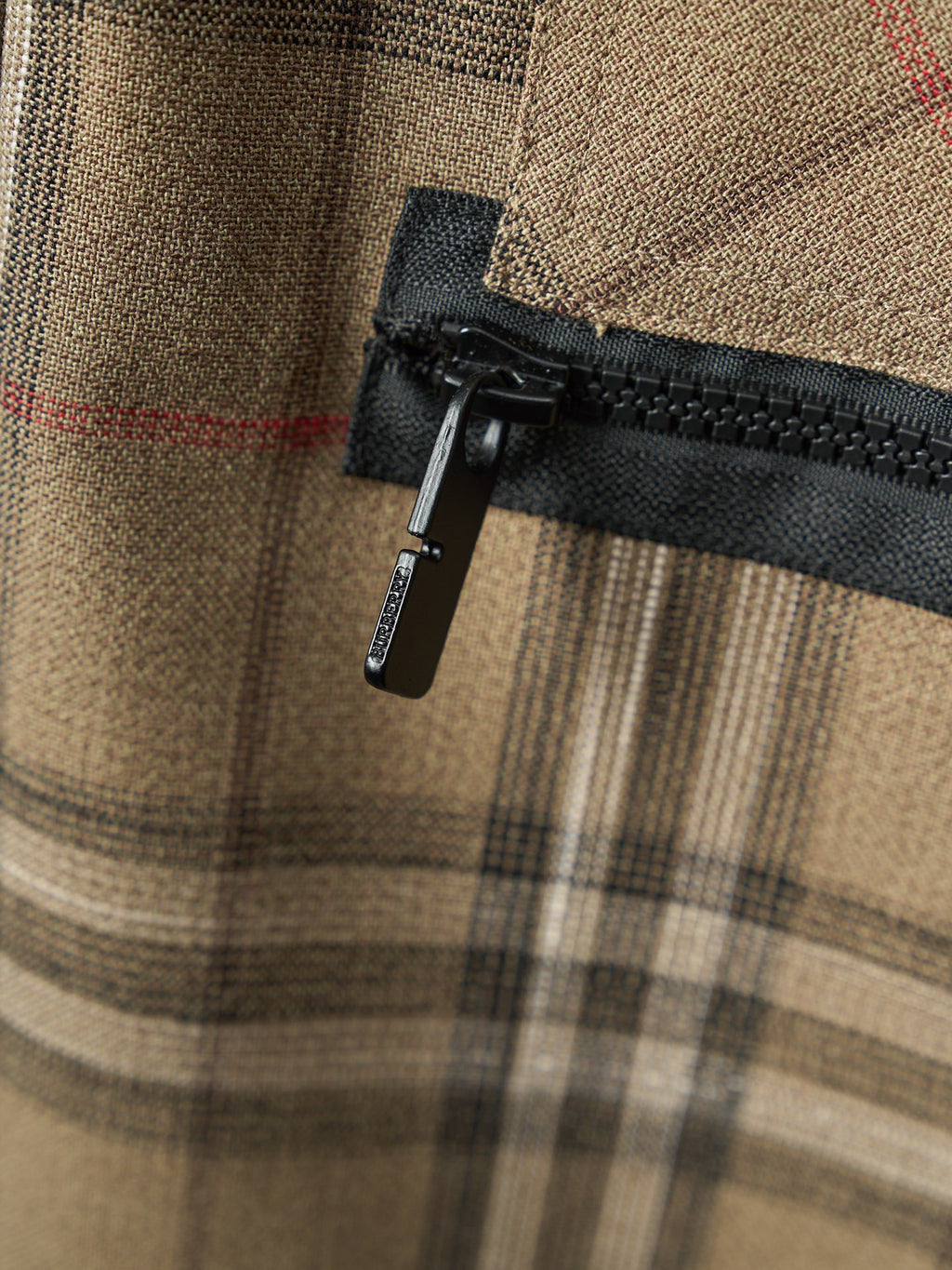 Burberry plaid pants with black zipper pull and woven fabric
