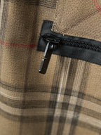 Burberry plaid pants with black zipper pull and woven fabric