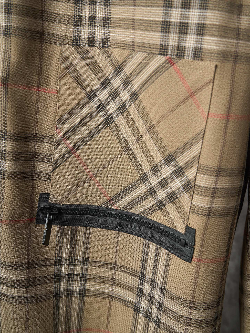 Burberry plaid pants with zippered pocket and black fabric flap