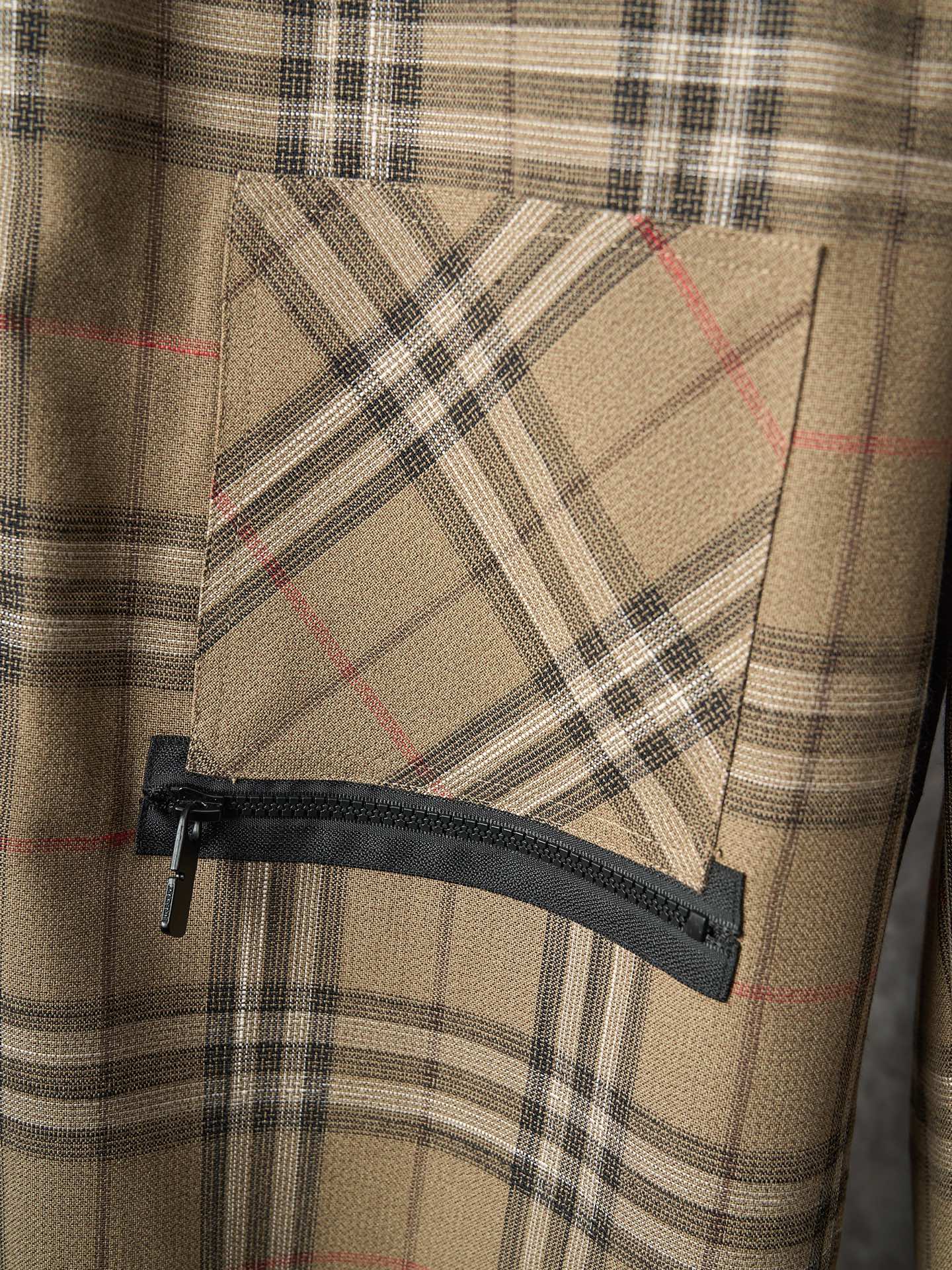 Burberry plaid pants with zippered pocket and black fabric flap