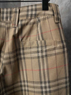Burberry plaid pants with front pocket flaps and black zipper trim