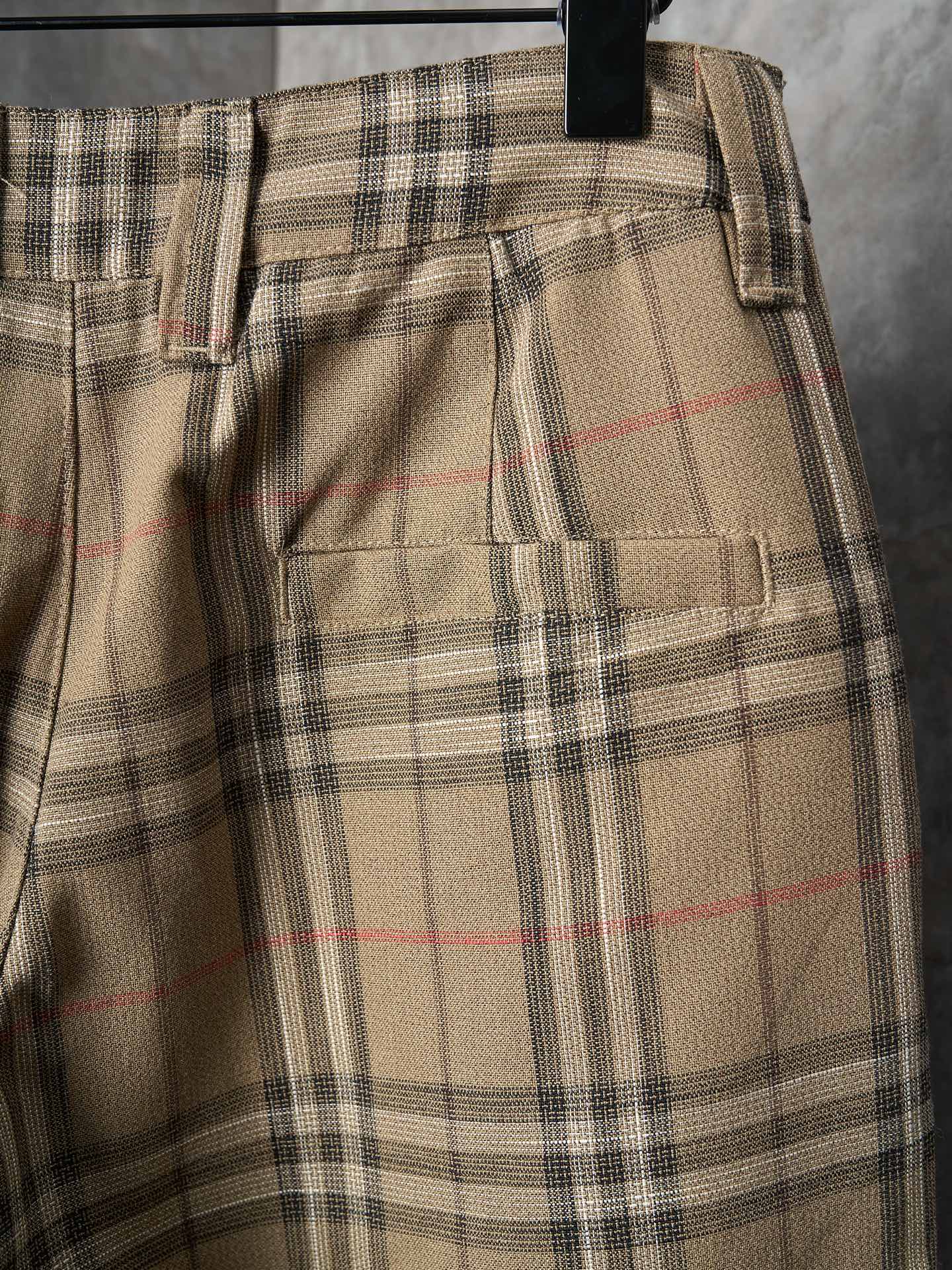 Burberry plaid pants with front pocket flaps and black zipper trim