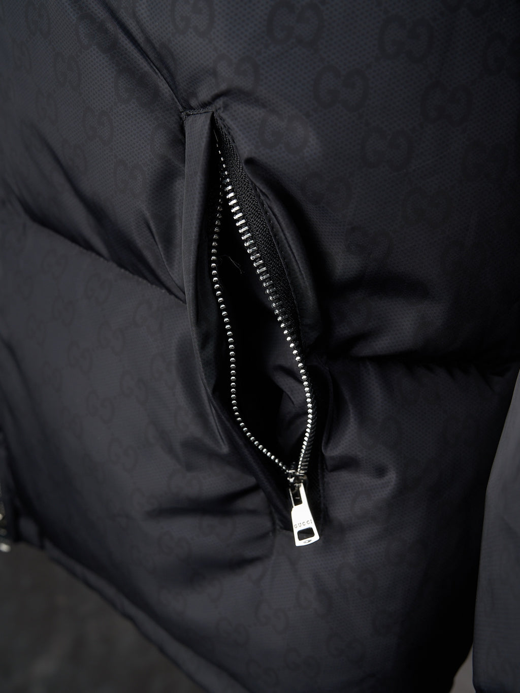 Gucci puffer jacket close-up of center front zipper, dark gray