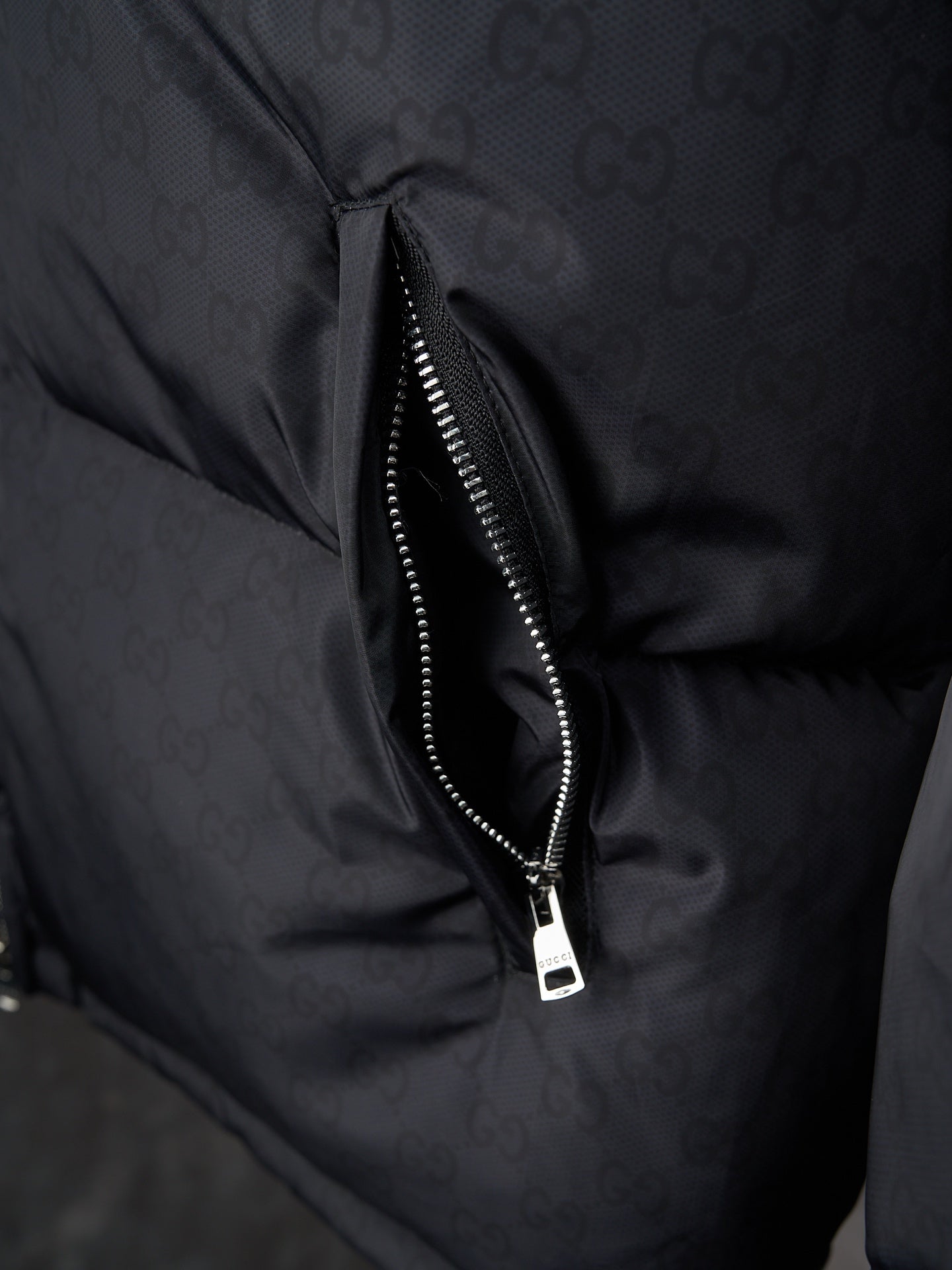 Gucci puffer jacket close-up of center front zipper, dark gray