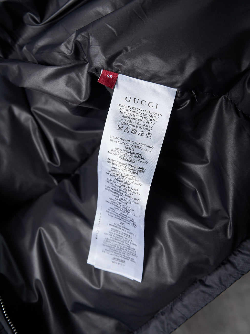 Gucci long jacket interior care label on black fabric