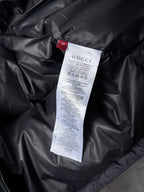 Gucci long jacket interior care label on black fabric