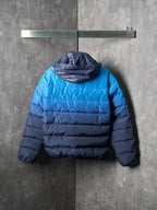 Blue puffer jacket with hood at back and horizontal padded quilting