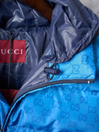 Blue monogram puffer jacket with side zipper and pocket detailing