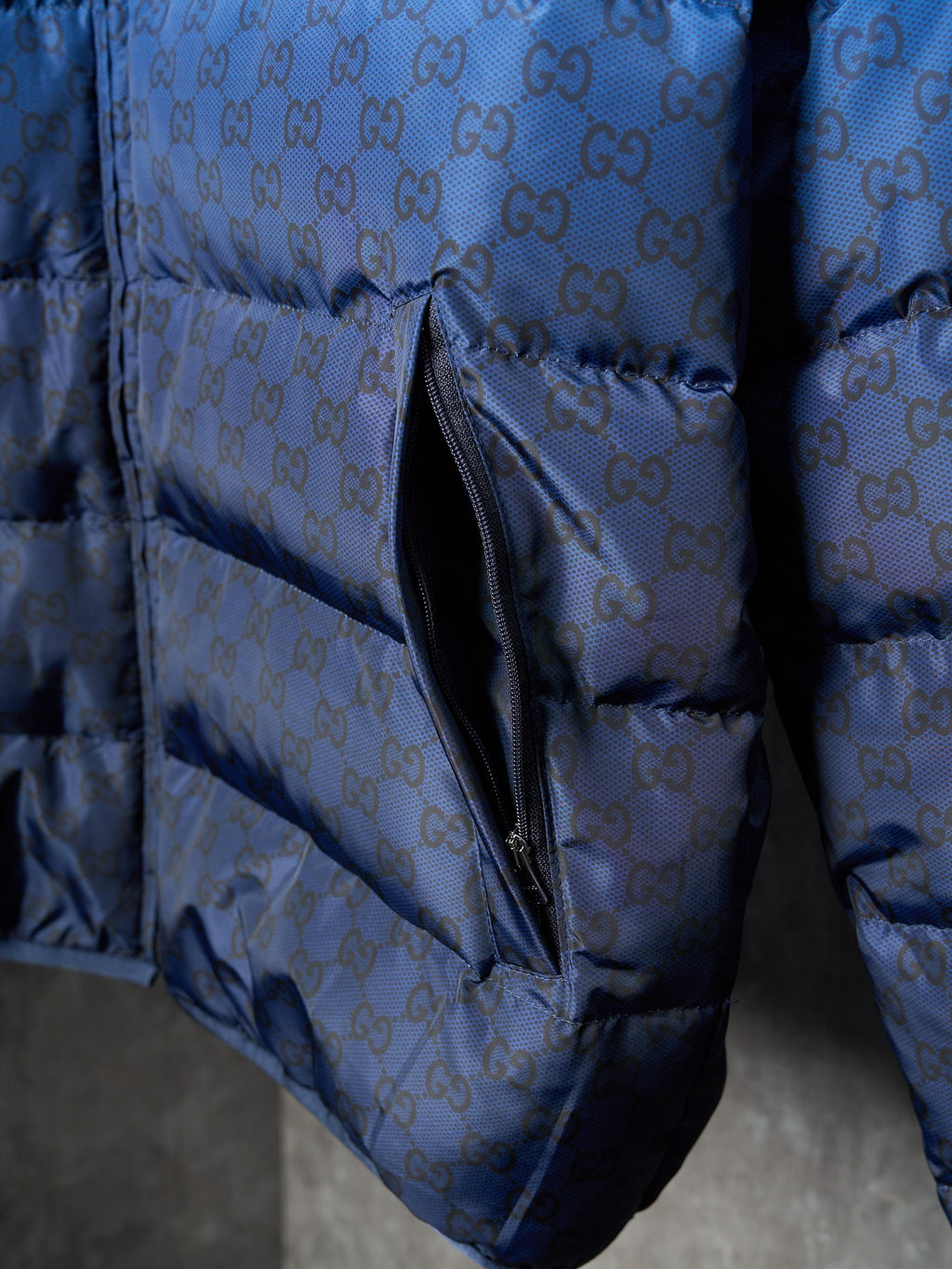 Blue monogram puffer jacket close-up of front side zipper and pocket seam