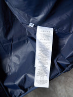 Gucci puffer jacket with white size label tag