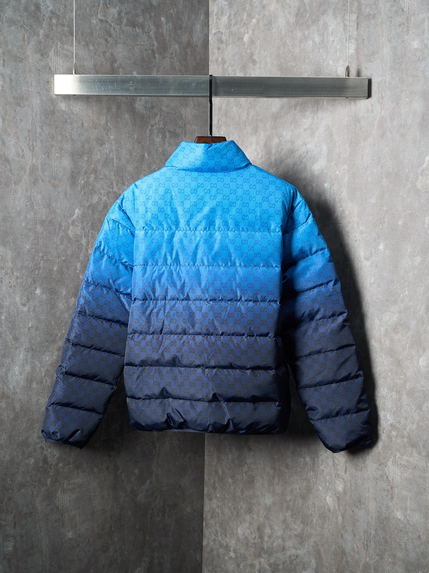 Blue puffer jacket back view with full-length quilting and hemline