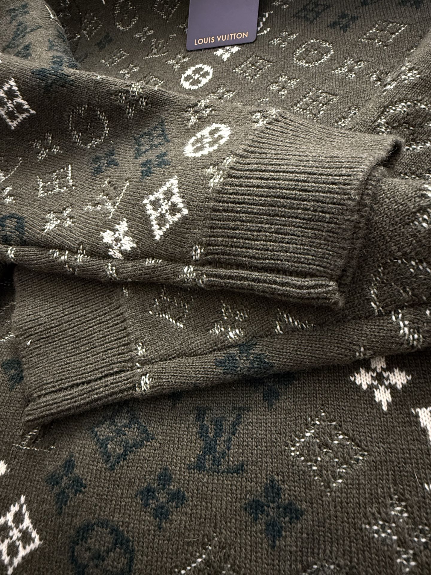 Brown knit sleeve cuff with ribbed hem and monogram pattern
