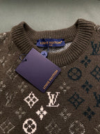 Brown knit sweater close-up with Louis Vuitton tag and monogram pattern