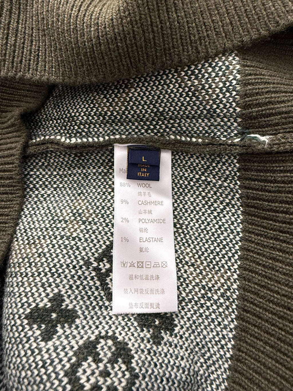 Brown knit sweater inside label with Louis Vuitton tag and fabric composition