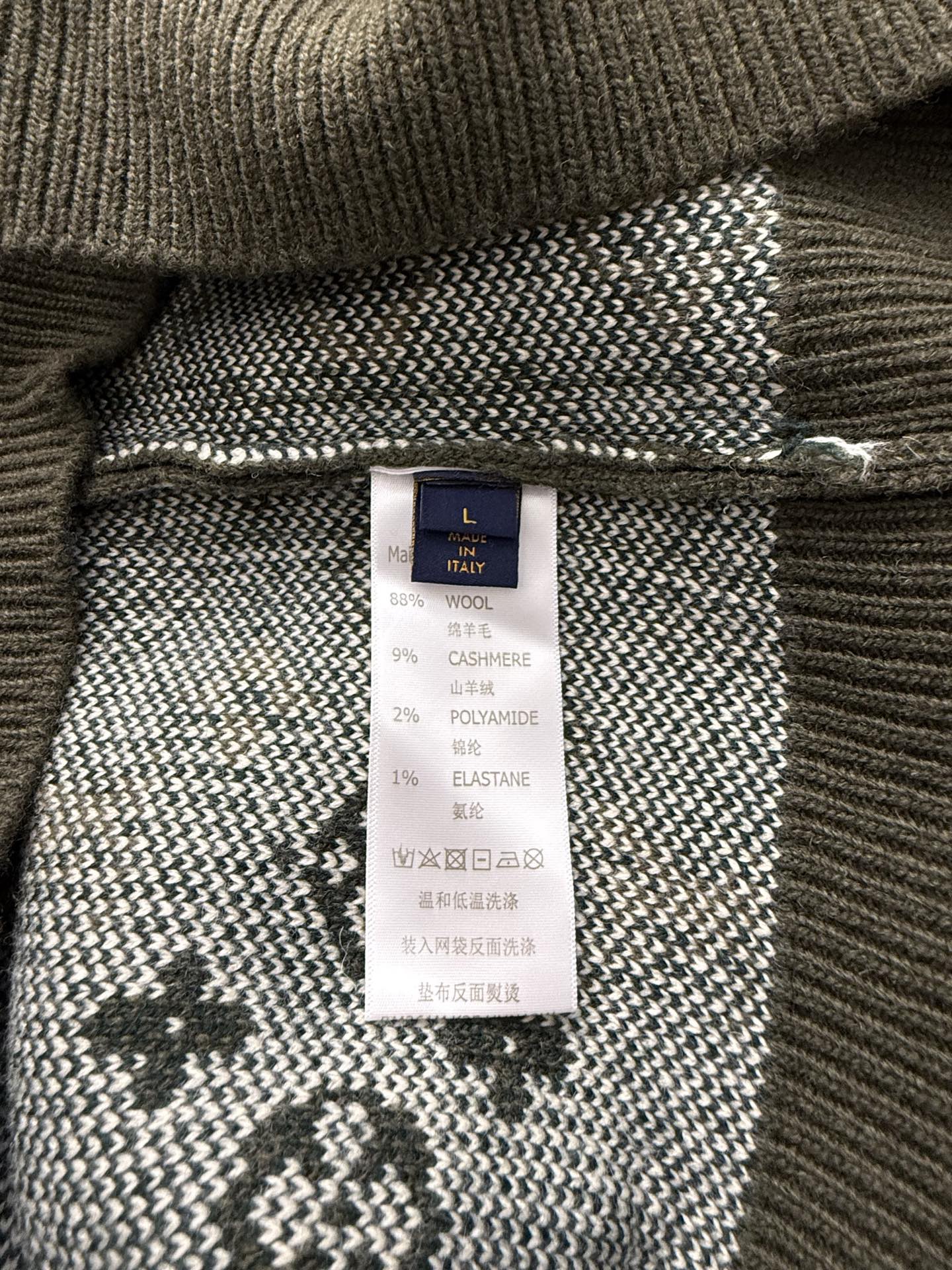 Brown knit sweater inside label with Louis Vuitton tag and fabric composition