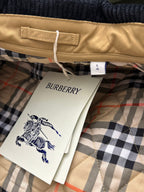 Tan quilted jacket hem with size tag and Burberry product tag on plaid lining
