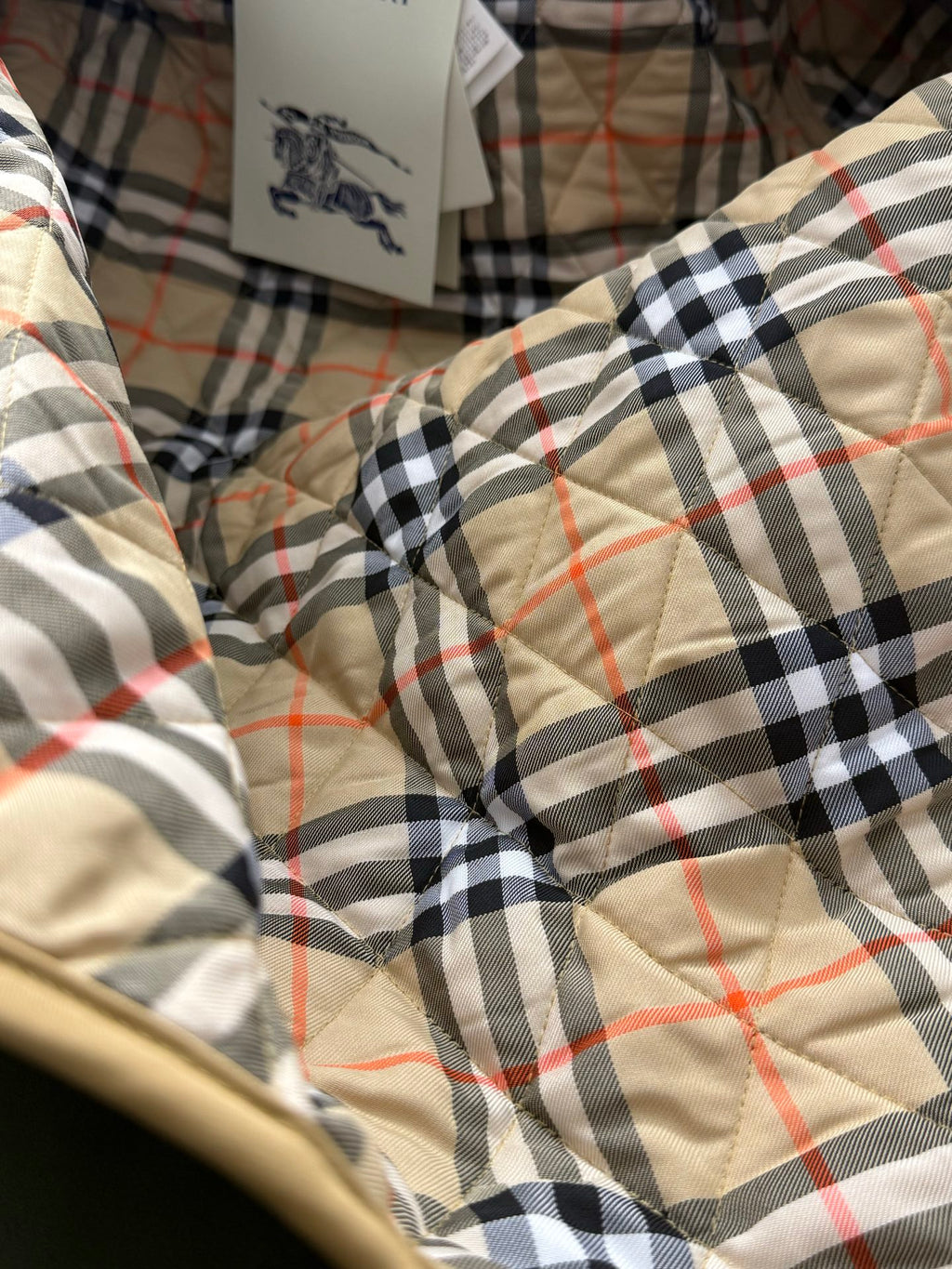 Plaid quilted jacket lining in black, cream, and red with stitched quilting