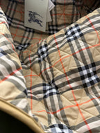 Plaid quilted jacket lining in black, cream, and red with stitched quilting