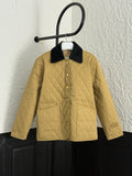 Burberry quilted jacket with black collar and button front, tan