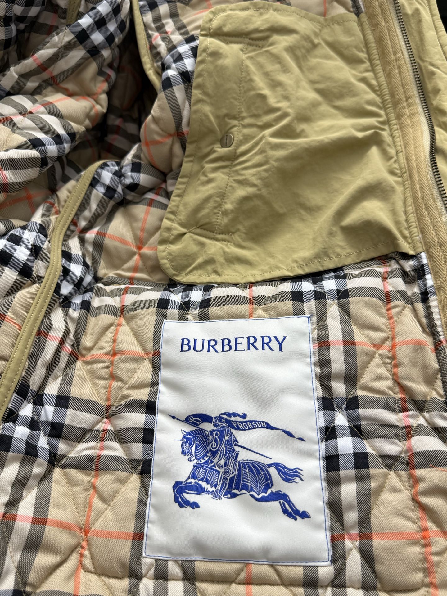 Burberry kids jacket lining with beige, black, and red plaid and horse tag