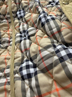 Burberry quilted jacket front with beige plaid lining and zipper