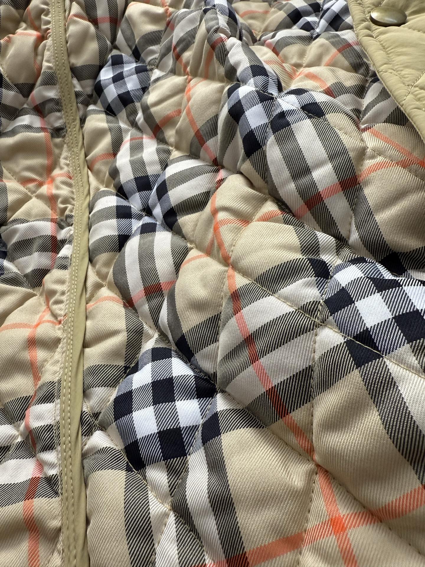 Burberry quilted jacket front with beige plaid lining and zipper