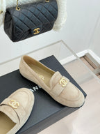 Beige suede loafer shoes with gold-tone CC logo detail on the front