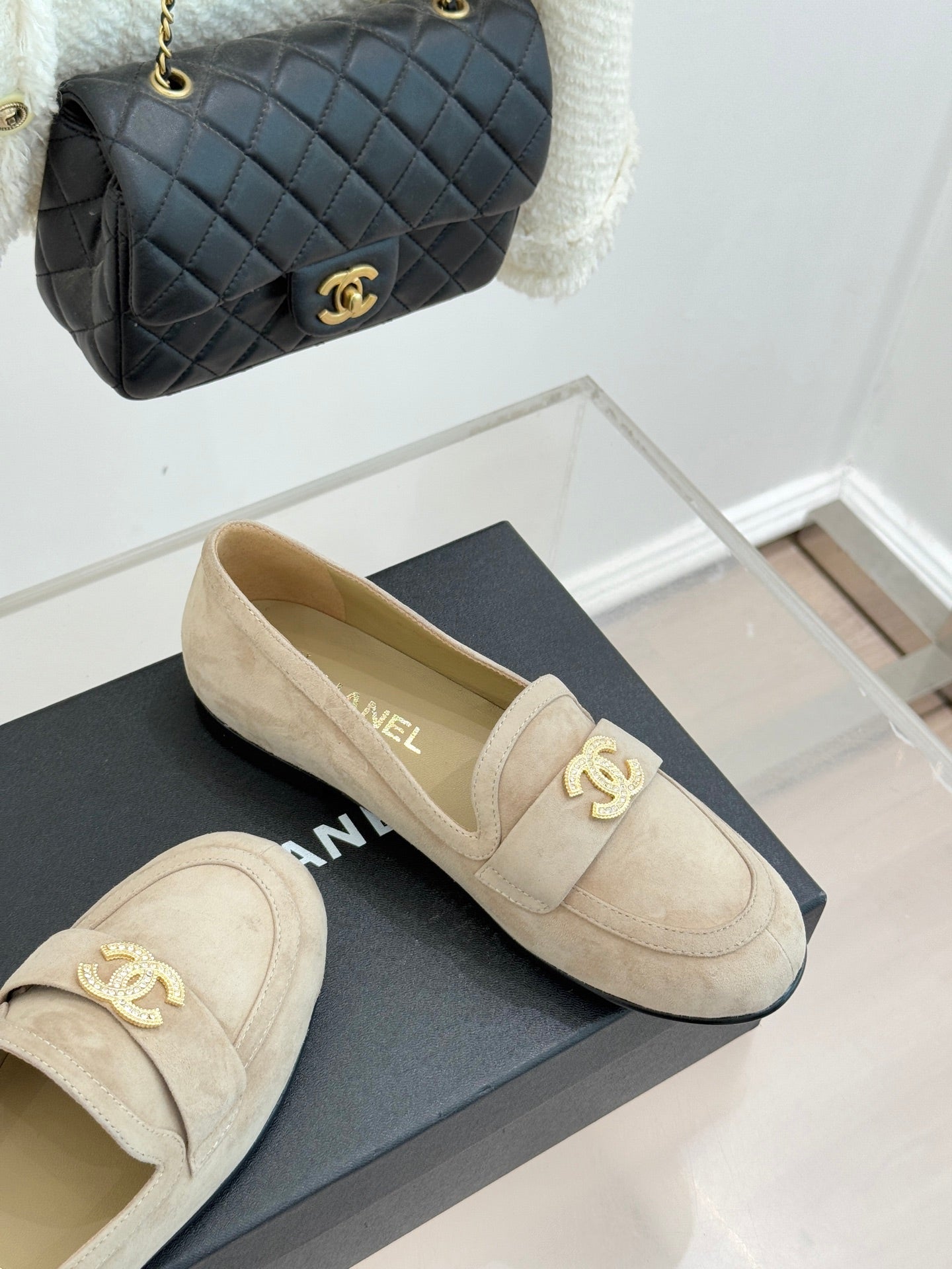 Beige suede loafer shoes with gold-tone CC logo detail on the front