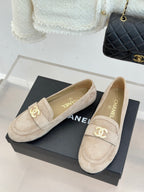Beige suede loafers with gold-tone CC logo and cushioned vamp strap