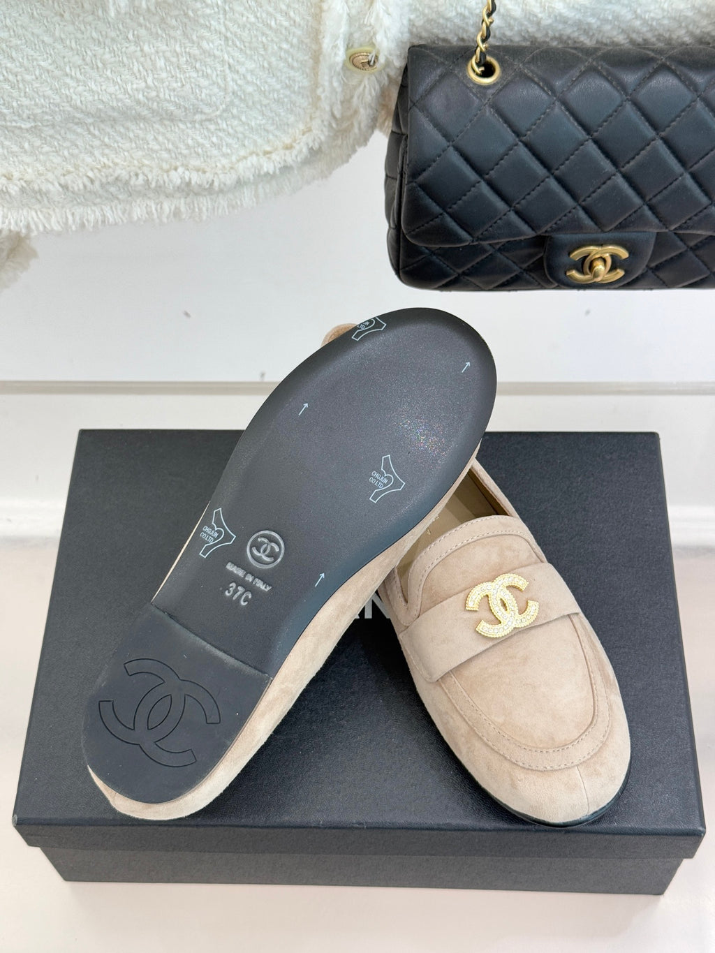Beige loafer shoes with dark outsole showing CC and CHANEL branding marks