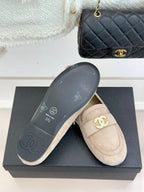 Beige loafer shoes with dark outsole showing CC and CHANEL branding marks