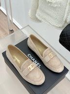 Beige suede loafer shoes with gold-tone CC logo and CHANEL lettering inside