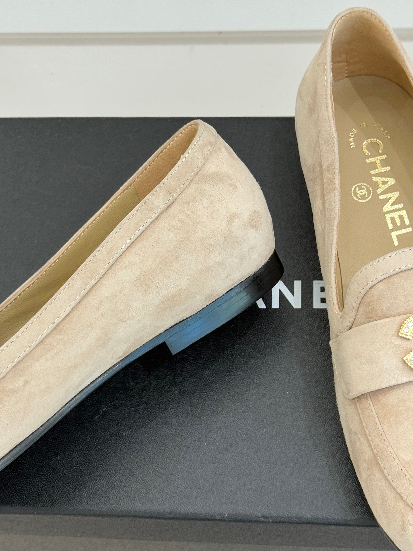 Beige suede loafers with curved vamp seam and low-profile outsole edge