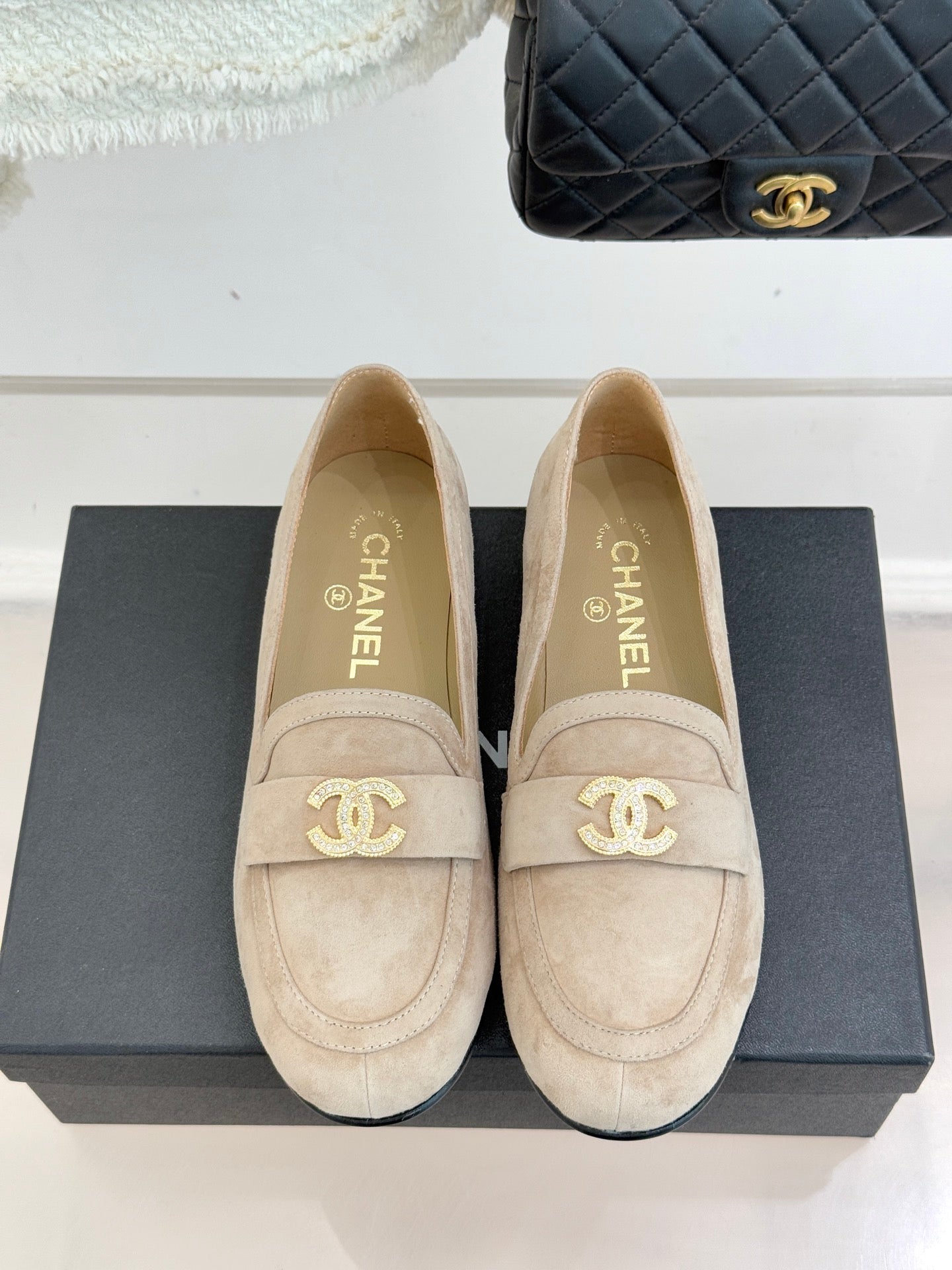 Beige suede loafers with gold-tone CC logo on vamp and CHANEL text on lining