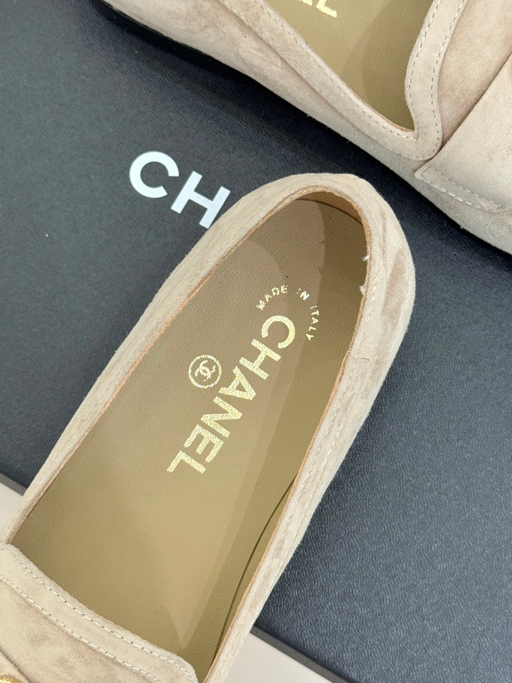 Beige suede loafer with gold CHANEL logo text on inner lining