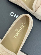 Beige suede loafer with gold CHANEL logo text on inner lining