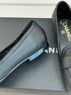 Chanel women’s black leather loafer showing stitching and low heel, close-up