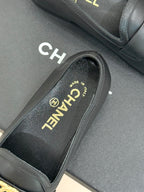 Chanel women’s black loafer close-up showing insole text and side edge