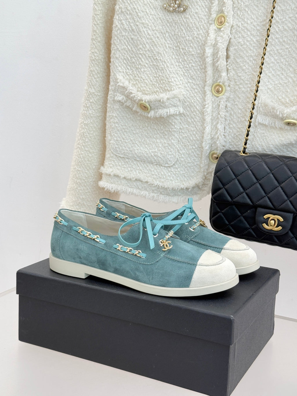 Chanel ladies blue suede sneakers with white rubber toe, teal laces, gold chain trim