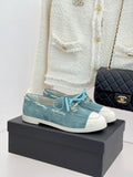 Chanel ladies blue suede sneakers with white rubber toe, teal laces, gold chain trim