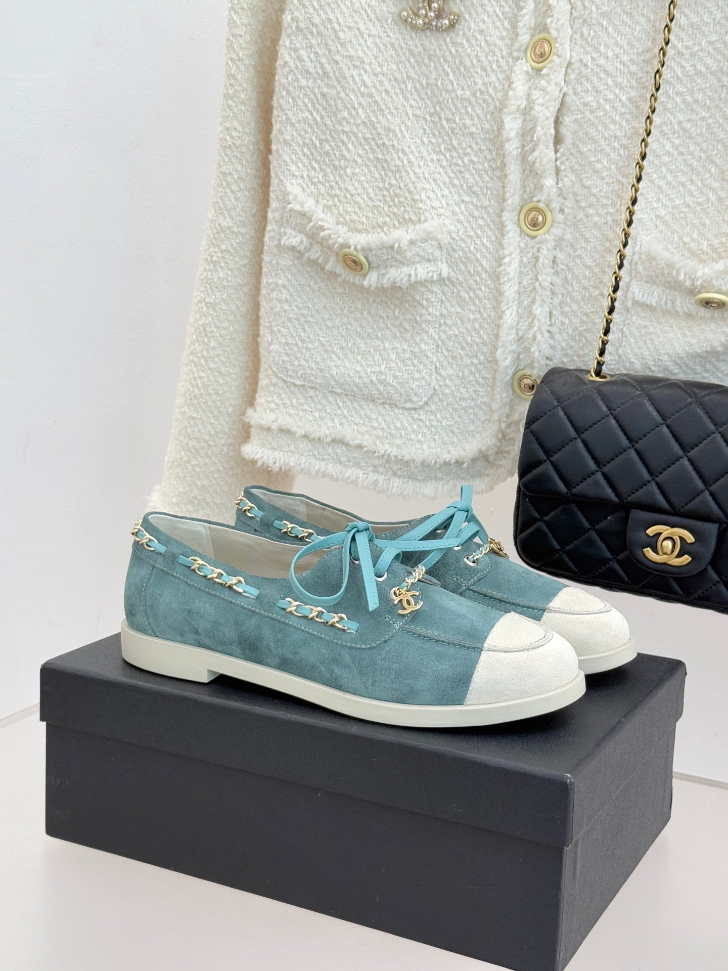 Chanel ladies blue suede sneakers with white rubber toe, teal laces, gold chain trim