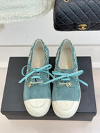 Chanel ladies blue suede sneakers with white toe caps, teal laces, gold chain straps