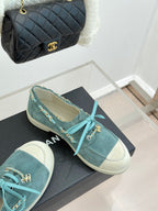 Chanel ladies blue suede sneakers, teal laces with gold chain links, on black box